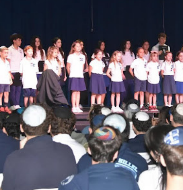 A photo of our Grade 2 students singing songs in honor of Yom Ha'Zikaron - Credit: @scheckhillel on Instagram