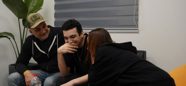 A photo of Edan Alexander reuniting with his family - Credit: CNN