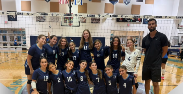 An image of our middle school girls volleyball team posing with Coach Fernandez! - Credit: @scheckhillel_lions on Instagram